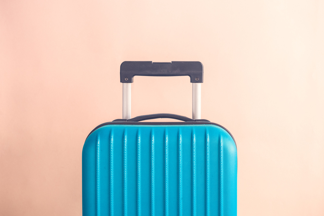 Luggage on beige background minimalistic vacation concept